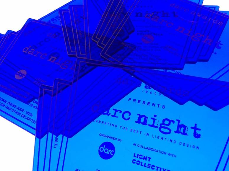 A pastiched image of darc night invitations, layered on one another and shaded blue.