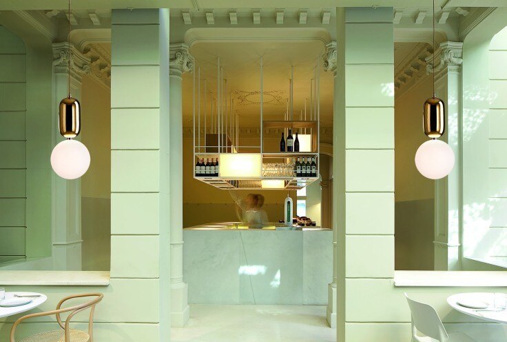 A wine bar enjoys the warm light of Jaime Hayón's Aballs pendant lights for Parachilna.