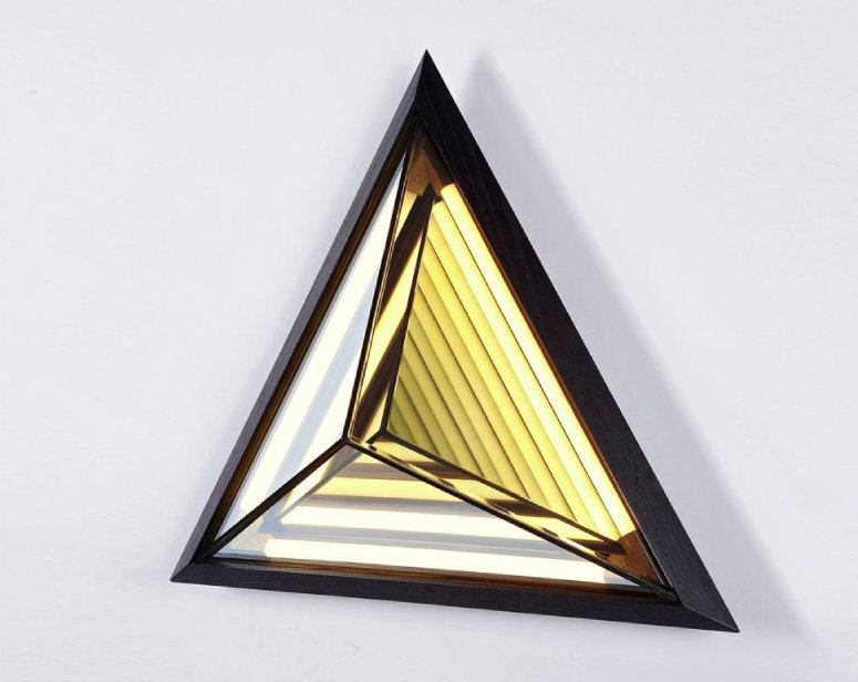 Roll & Hill's Stella wall light, designed for Roll & Hill by Rosie Li, seen from an angle to reveal the complexity of its inner reflections.