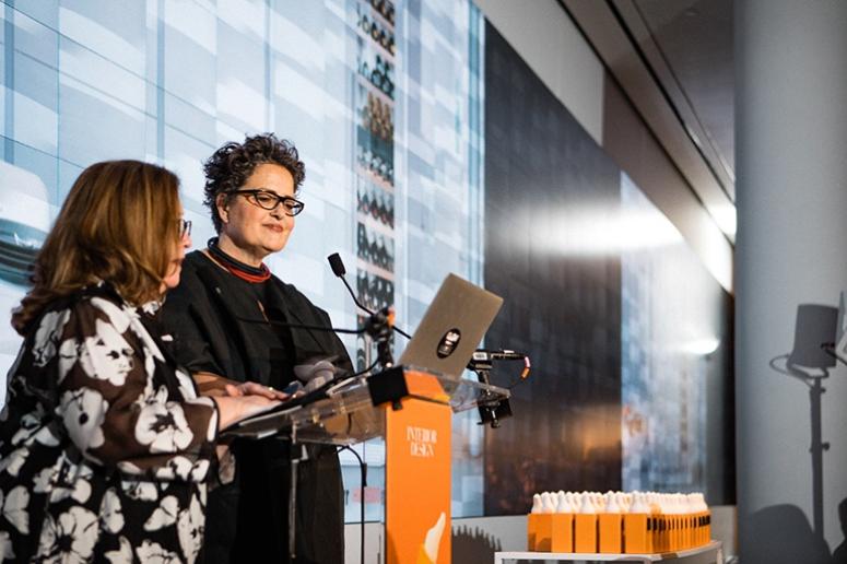 A photo of host Carol Cisco at the lectern at Interior Design magazine's BoY Awards ceremony.