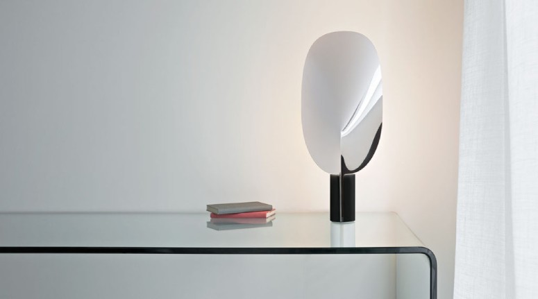 Serena table lamp, designed by Patricia Urquiola for FLOS, sits on a glass sideboard.