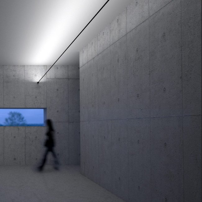 Davide Groppi's Infinito wall light illuminates a concrete hall. Davide Groppi's blur walks beneath it.