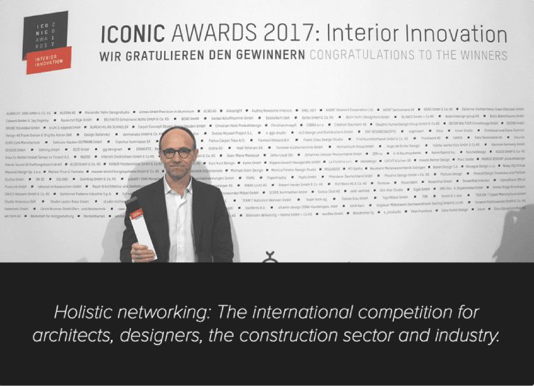A man poses with his ICONIC Award on the 2017 ceremony's red carpet.