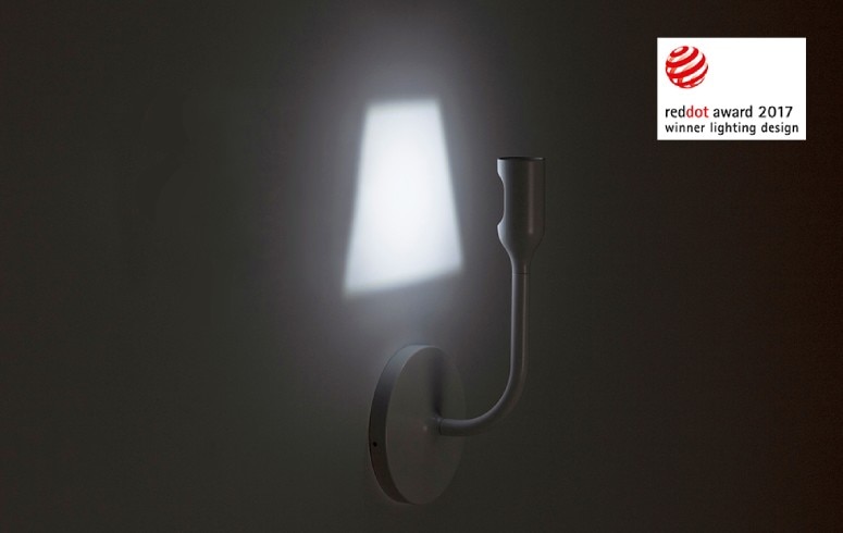 A close up of Innermost's YOYWall wall sconce showing the way the lampshade shape is produced by the sleek restrained lighting head.