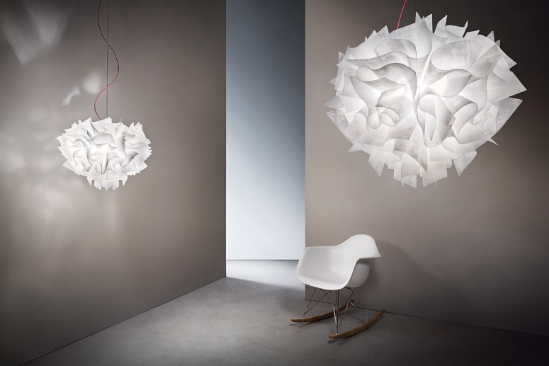 A studio set highlighting the minimalist luxury of the Veli pendant light's presence.