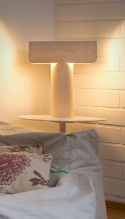 Teelo 8020 table lamp provides warm general lighting over a living room from a sofa end table.