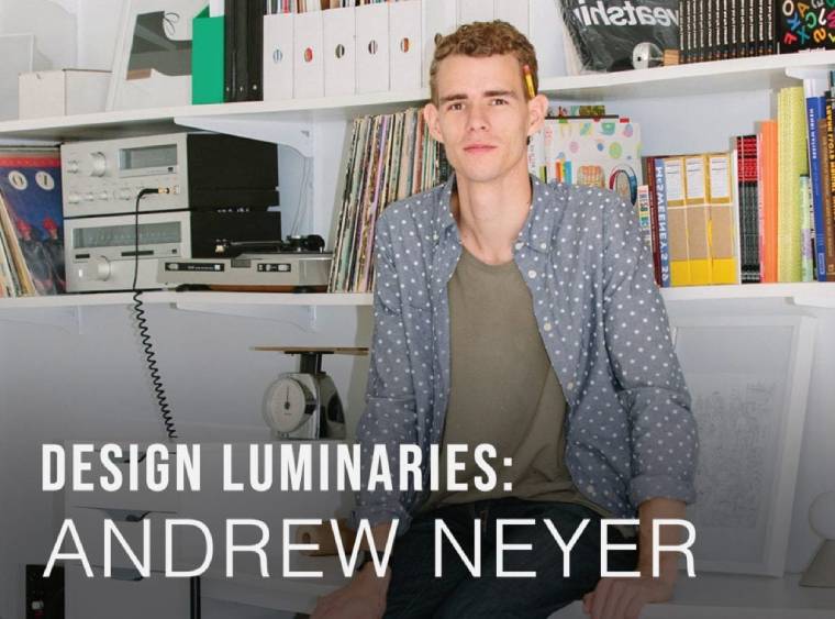 Lighting designer Andrew Neyer poses in his workshop and studio with a pencil jauntily stuck behind his ear. Text on Image: Design Luminaries: Andrew Neyer