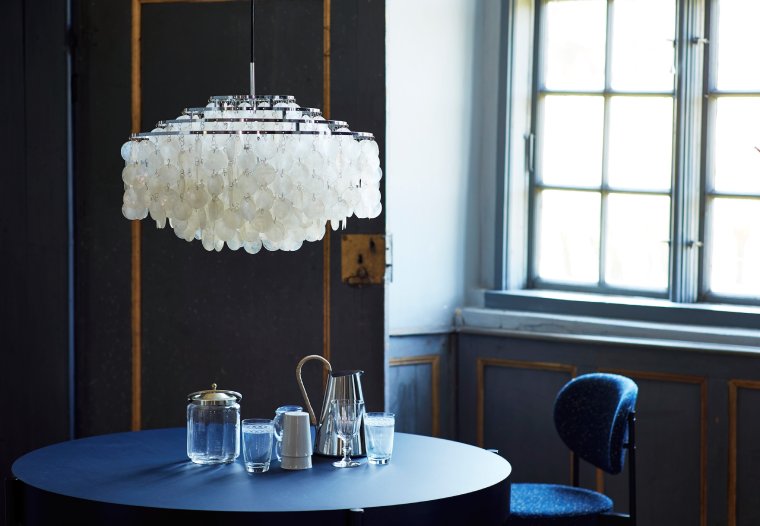 Verner Panton's Fun 10DM suspension light hangs over a café table while the crisp Nordic sunlight filters through a nearby window.