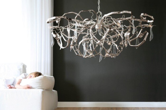 Brand van Egmond's Delphinium Round suspension light hangs to the side of a sofa upon which rests a small child.