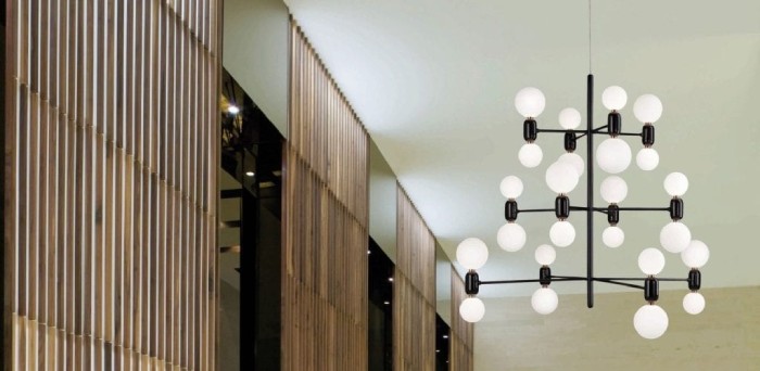 Parachilna's Aballs 12 Chandelier suspension light hangs above a spacious lobby.