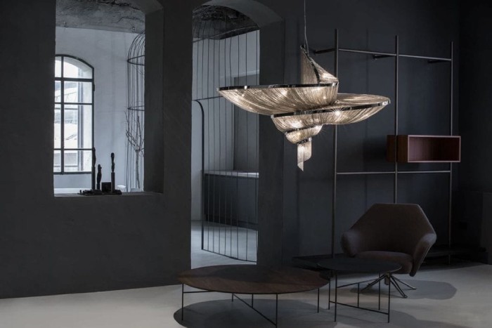 A sleek, minimalist contemporary living room enjoys the drama of Terzani's Epoque suspension light.