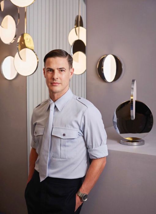 Lighting designer and two-time Elle Deco Internation Design Award winner Lee Broom poses with his Eclipse Collection, including table, wall, and pendant lights.