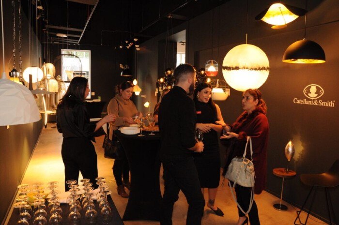 LightForm and Dwell Modern representatives share drinks, appetizers, and conversation with guests in front of a Catellani & Smith display in LightForm's new Calgary showroom.