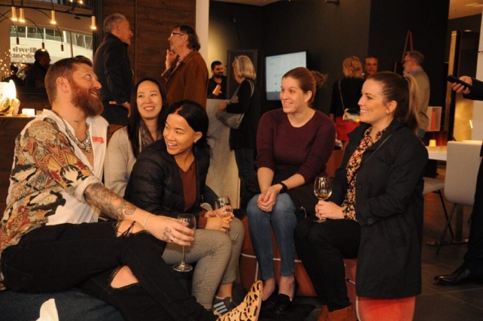 LightForm representatives and guests share a laugh at the grand opening of LightForm Calgary.