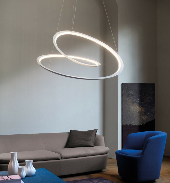 NEMO's Kepler pendant light in white hangs over the coffee table in a simple yet comfortable living room.