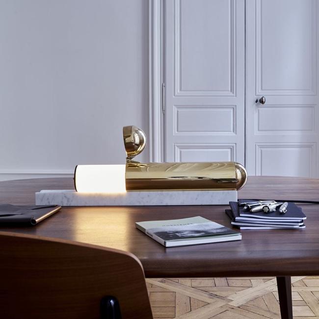 Ilia Sergueïevitch Potemine's endlessly-inventive ISP table light from DCWéditions sits on a wooden table being used as a desk.