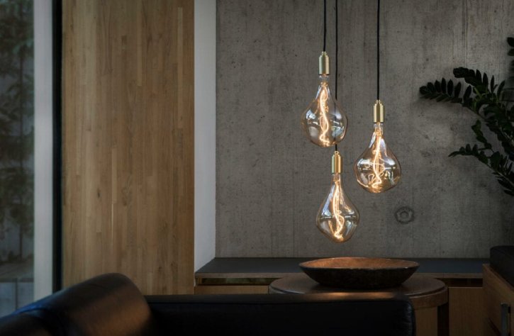 Tala's Voronoi II Triple Pendant cluster suspension light hangs above an end table next to a comfortable couch.