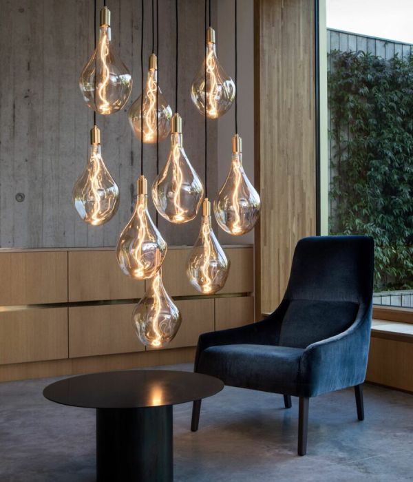 Tala Voronoi III Nine Pendant suspension cluster illuminates a simple living room.