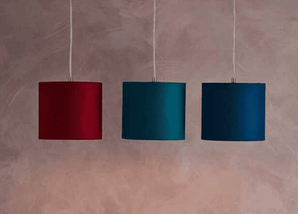 Three bespoke drum pendant lights with diffusers made from Innermost's WenLock material in Red, Ocean Blue, and Navy.