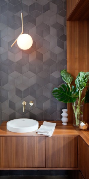 IC Light pendant, designed by Michael Anastassiades for Flos, hangs over a bathroom sink