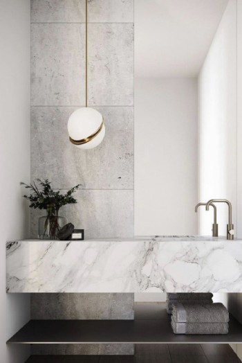 British lighting designer Lee Broom's Mini Crescent pendant hangs next to a bathroom vanity