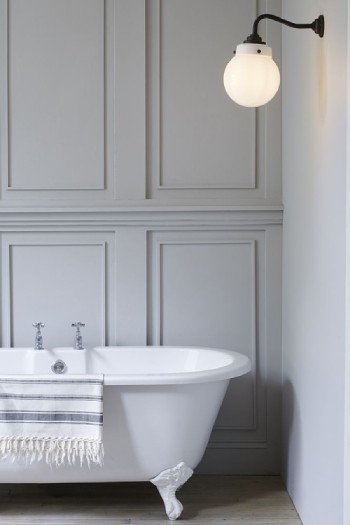 Hampton wall light illuminates an elegant clawfoot bathtub.