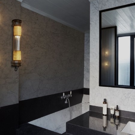 In the Tube outdoor wall light installed in a sleek, contemporary bathroom.