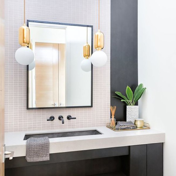 A bathroom vanity with Parachilna's Aballs pendants hanging to either side