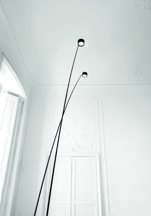 A pair of Sampei floor lamps tower over the camera.