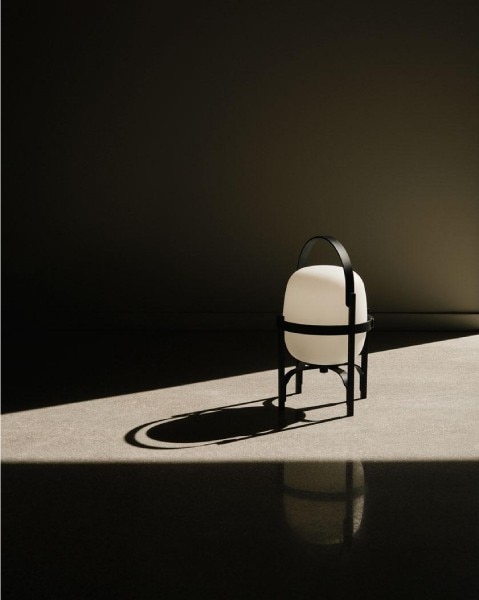 A dramatic photo of Cestita Alubat outdoor portable light throwing a long shadow in a splash of sunlight.