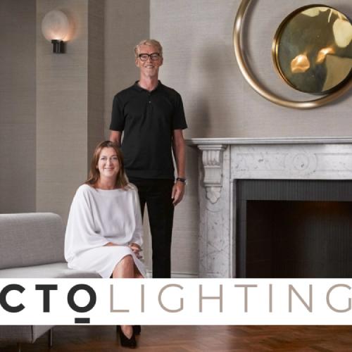 CTO Lighting founders Chris and Clare Turner pose with Nimbus wall sconce in the background.