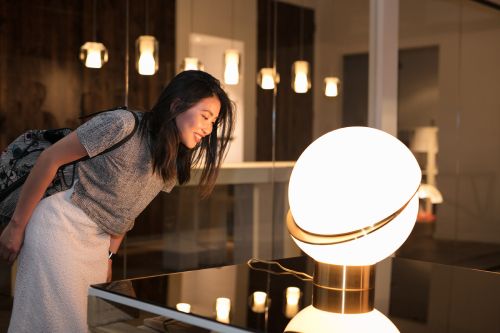 A visitor to our Toronto showroom during an event hosting designer Lee Broom basks in the light of Broom's Mini Crescent table lamp.