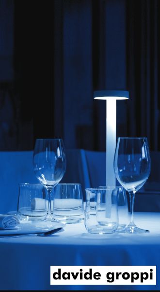 TeTaTeT portable table lamp, one of the signature creations by Davide Groppi both as a designer and a brand, in an intimate fine dining atmosphere.