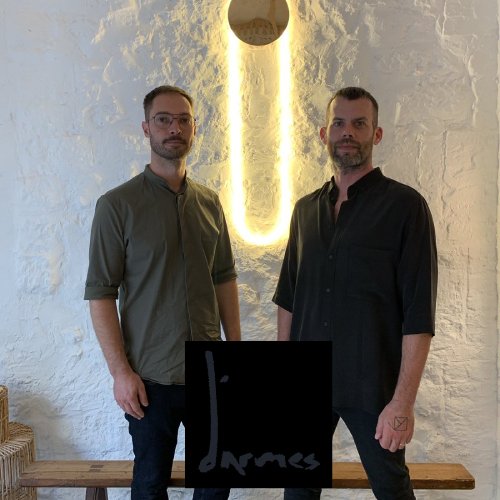 Founders of Studio d'Armes, Alexandre Joncas and Gildas Le Bars pose in front of their RA wall sconce.