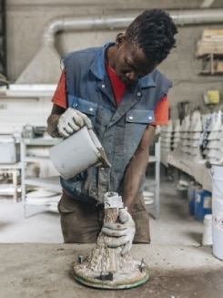 One of Foscarini's craftsmen pours the unique concrete mix created to give the Aplomb family form.