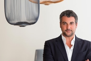 CEO of Foscarini North America and South America, Renato Delle Side with Spokes 1 suspension light.