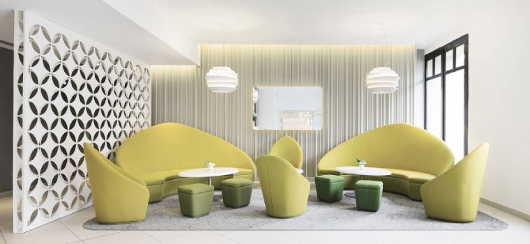 A pair of Foscarini's Le Soleil pendants illuminate a sitting area at Holiday Inn Paris.