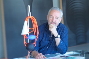 Founder and President of Foscarini, Carlo Ubinati with Filo table lamp.