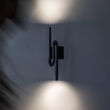 Tobia wall sconce on a living room wall.