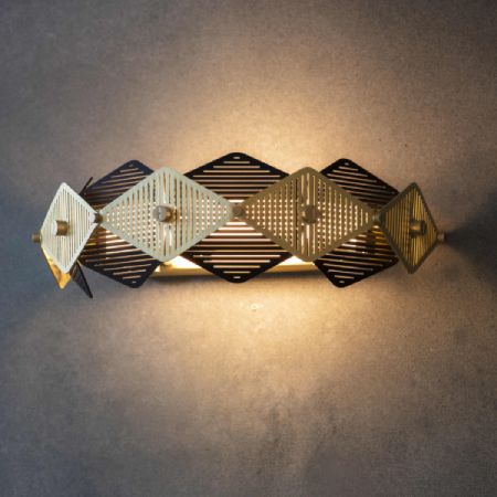 Bert Frank's Rote wall sconce illuminates a textured wall.