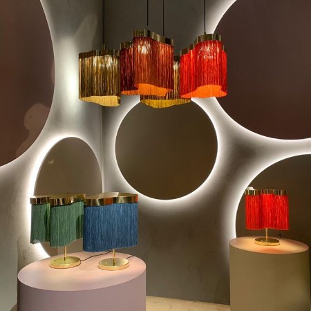 Contardi Arcipelago pendant lights in a range of colours hang over an equally-multicolour selection of Arcipelago table lamps on a sixties-inspired set.