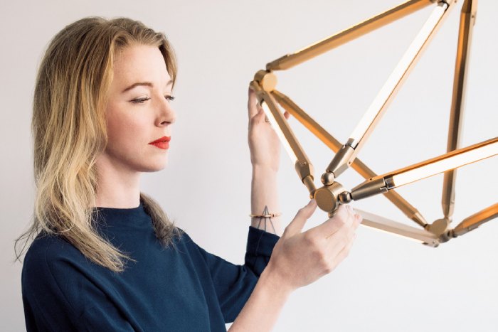 Lighting designer Bec Brittain poses with one of her designer lights.