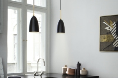 A pair of Gräshoppa suspension lights in a sleek contemporary kitchen