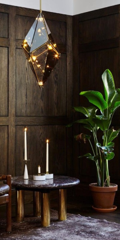 Bec Brittain's Maxhedron Vertical 24 inch pendant light for Roll & Hill hangs above a marble end table in a luxurious oak-panelled study.