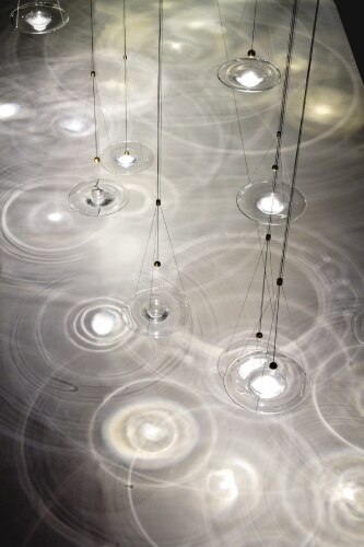 A view from above of an installation of Wonderglass' Momento pendant lights and the remarkable light-and-shadow effects they cast upon the floor.