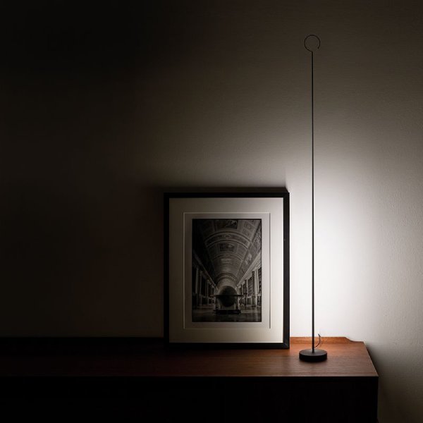 Anima floor and table light from Davide Groppi sits on a side table