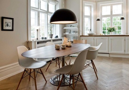 Skygarden pendant light, designed for Flos by Marcel Wanders, hangs over a dining table in an open-concept kitchen.