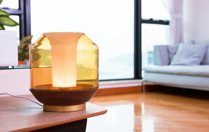 Ben McCarthy's Lateralis table light from Innermost sits foregrounded in a calmly welcoming living room.