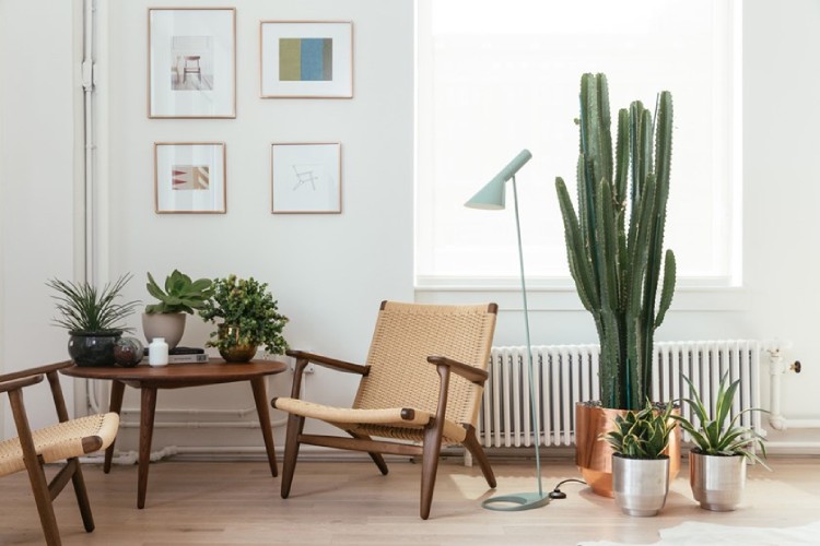 AJ floor lamp, designed for Louis Poulsen by Arne Jacobsen, sits in a vibrant yet dignified Japandi living room.