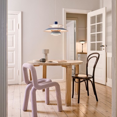 The iconic PH 5 suspension light, designed for Louis Poulsen by Poul Henningsen, illuminated above a Japandi-inspired dining room.